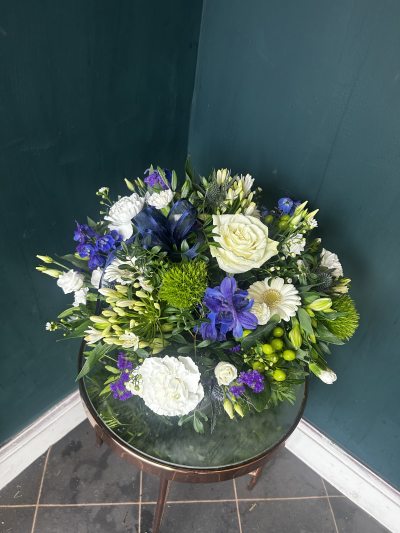 The One and Only - A simply stunning petite arrangement in shades or blue, white and green. 

All round the flowers display from the container making it perfect for a table centre. 

Made into floral foam The One and Only is a low maintenance gift that’s simple and stunning.

Please note flowers may vary due to seasonal availability